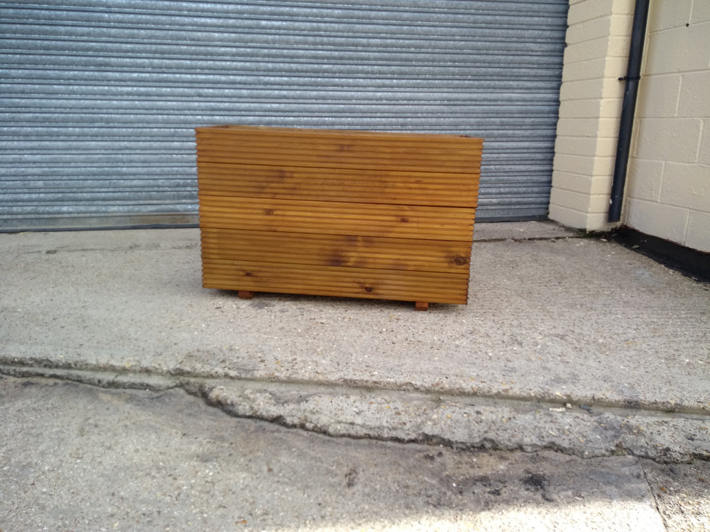 5 rows of decking large trough wooden planters stained with a Light Oak finish