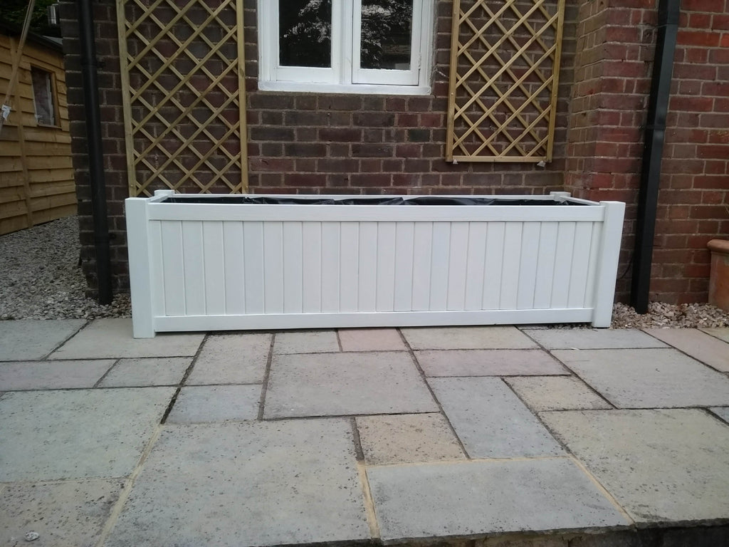 Versailles trough planters painted with Cuprinol's Pale Jasmine (no finials)