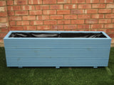 3 rows of decking trough wooden planters painted in Cuprinol Forget Me Not