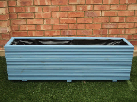 3 rows of decking trough wooden planters painted in Cuprinol Forget Me Not