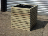 Block style square wooden planters with spaces between the rows
