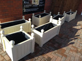 Versailles trough planters painted with Cuprinol's Country Cream