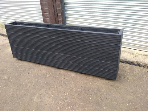 5 rows of decking large trough wooden planters painted in Cuprinol's Black Ash