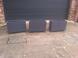 Smooth trough wooden planters with 4 rows of planks on wheels, painted with Cuprinol's Urban Slate